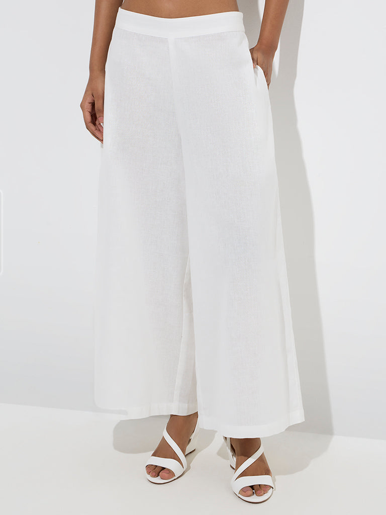 Utsa White Solid Cotton Palazzos - Image 2